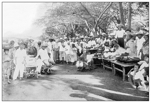 Antique black and white photograph of people from islands in the Caribbean and in the Pacific Ocean; Cuba, Hawaii, Philippines and others: Outdoor restaurant, Cavite, Philippines