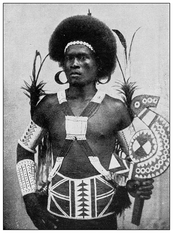 Antique black and white photograph of people from islands in the Caribbean and in the Pacific Ocean; Cuba, Hawaii, Philippines and others: Papuan warrior