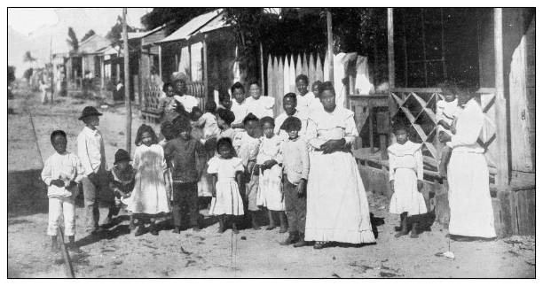 Antique black and white photograph: Teacher and school students, Catano, Puerto Rico Antique black and white photograph of people from islands in the Caribbean and in the Pacific Ocean; Cuba, Hawaii, Philippines and others: Teacher and school students, Catano, Puerto Rico puerto rican women stock pictures, royalty-free photos & images