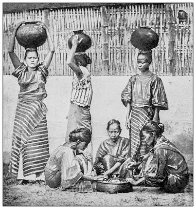Antique black and white photograph of people from islands in the Caribbean and in the Pacific Ocean; Cuba, Hawaii, Philippines and others: Water carriers and fruit vendors, Manila, Philippines