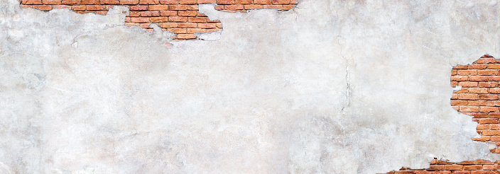 Damaged plaster on brick wall background. Brickwork under crumbling texture  concrete surface