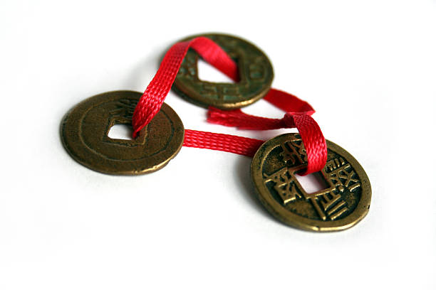 Antique Chinese Coins Antique Chinese coins on a red string, that bring good luck.  chinese lucky coins stock pictures, royalty-free photos & images