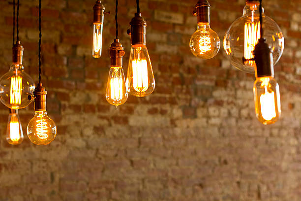 Antique Light Bulbs Decorative antique edison style light bulbs against brick wall background led light photos stock pictures, royalty-free photos & images