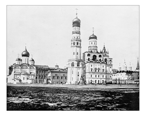 Antique photograph of Moscow Kremlin (Russia) in a picture of the 19th century taken from the moat that surrounded the site: the 15th-16th century fortified complex (citadel) overlooking the Moskva River is a UNESCO World Heritage Site and includes the walls, the towers, the cathedrals and the Tsar Bell.