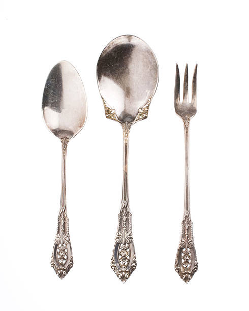 Antique silver spoons and fork on white background stock photo