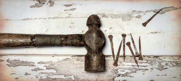 Antique Ssquare Nails and vintage hammer stock photo
