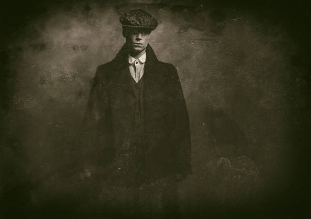 Antique wet plate photo of mysterious 1920s english gangster with flat cap and black coat. Antique wet plate photo of mysterious 1920s english gangster with flat cap and black coat. gangster stock pictures, royalty-free photos & images