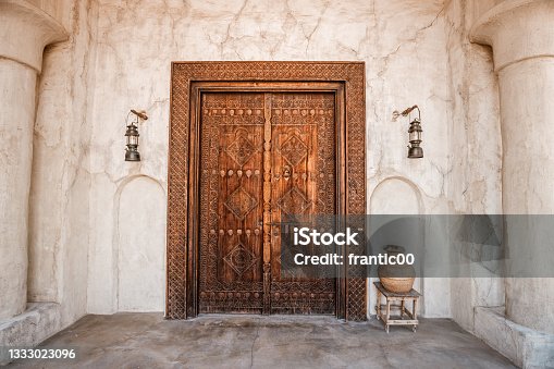istock Antique wooden door with architectural arch in an ancient sandstone house in Bur Dubai near Creek area 1333023096