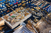 istock Antiques on flea market or seasonal festival - vintage jewelry, silver brooches and other vintage things. Collectibles memorabilia and garage sale concept. Selective focus 1314069418