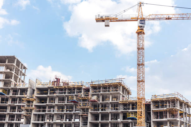 apartment building under construction with scaffolding stock photo