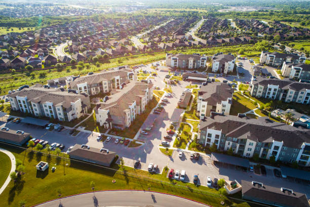 Apartments and Suburbs in Austin Texas at Sunrise Apartments and Suburbs in Austin Texas - aerial drone view at sunrise with lens flare above new developments flat physical description stock pictures, royalty-free photos & images