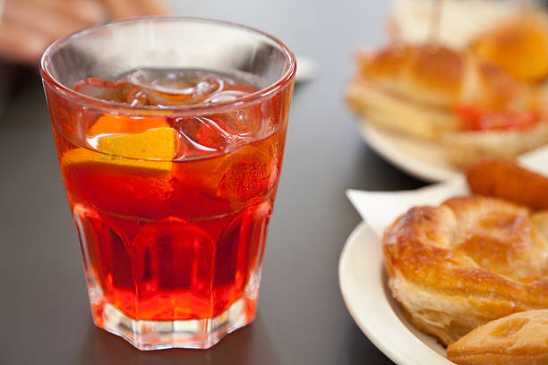 Appetizer At The Bar Glass of Spritz and salty flaky pastries. aperitif stock pictures, royalty-free photos & images