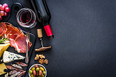 istock Appetizer frame: red wine, Iberico ham and cheese on rustic table 1183406630