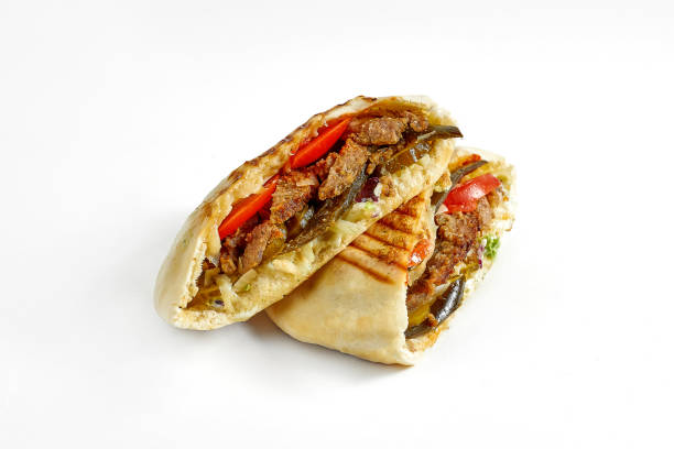 Appetizing pita with jalapeno peppers, red sauce, vegetables and beef isolated on a white background stock photo