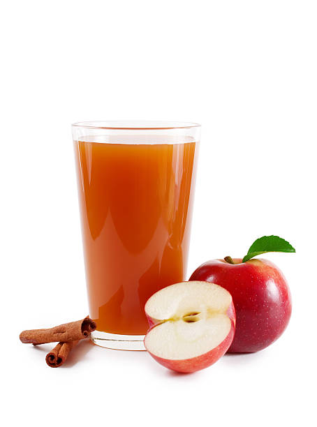 Apple cider glass decorated with fresh apples and cinnamon A glass of apple cider on white cider stock pictures, royalty-free photos & images