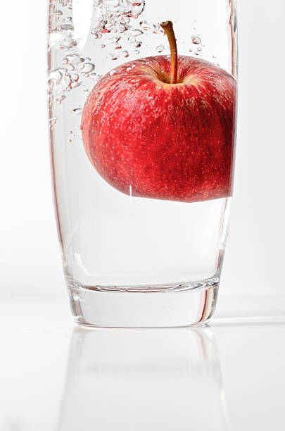 Apple drop into glass stock photo