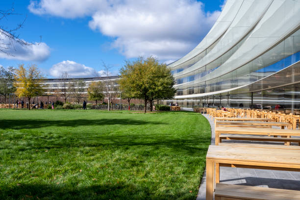 Apple headquarters offices building exterior and inner court with outdoor eating area, on a bright cold December day. stock photo