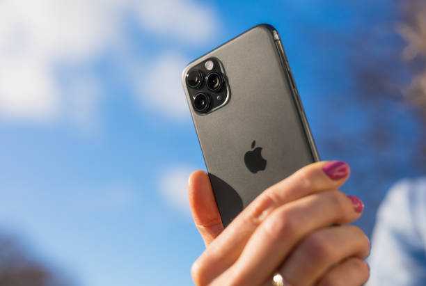 Apple iPhone 11 Pro smartphone in hand of a person Riga, Latvia - October 28, 2019: Person holding in hand latest Apple iPhone 11 Pro smartphone with triple lens camera. iphone stock pictures, royalty-free photos & images