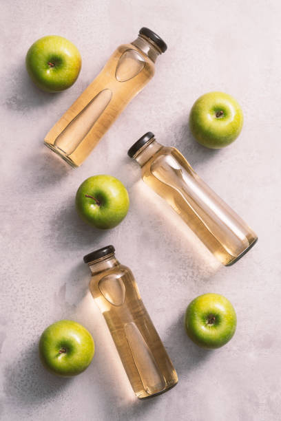 Apple juice and apples on kitchen countertop stock photo
