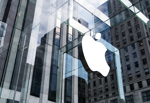 New York, United States - May 19, 2016: Glass building of the Apple Store with huge Apple Logo at 5th Avenue near Central Park. The store is designed as the exterior glass box above the underground display room