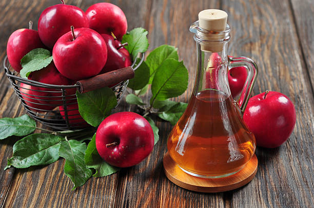 apples and apple cider vinegar stock photo