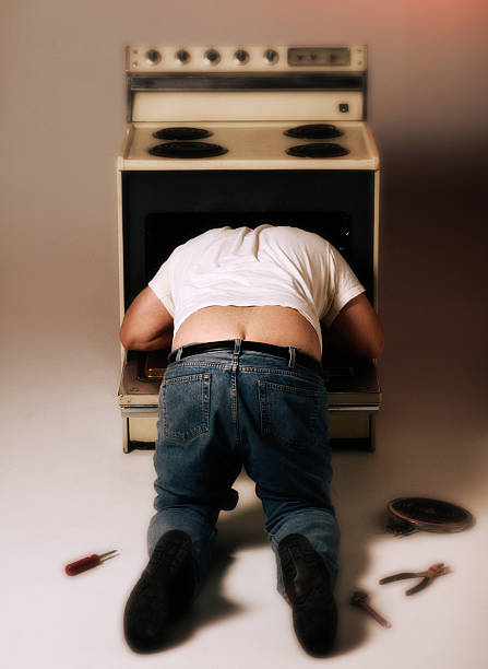 appliance repairman - plumber's crack stock photos and pictures.