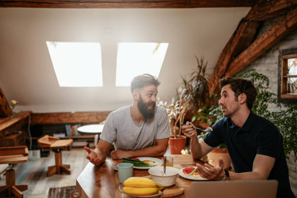 I appreciate your opinion, man! Shot of two male friends chatting over breakfast roommate stock pictures, royalty-free photos & images