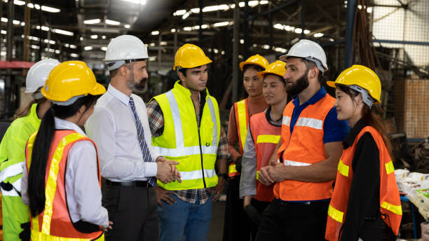 Appreciation and happiness among a team of factory engineers stock photo