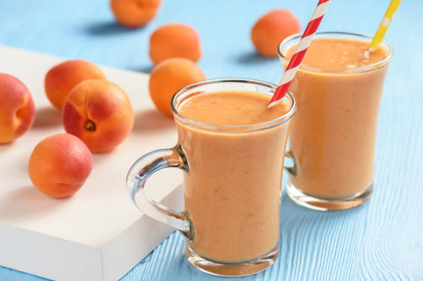 Apricot smoothie, healthy beverage, on wooden background. Apricot smoothie, healthy beverage, on wooden background. peach smoothie stock pictures, royalty-free photos & images
