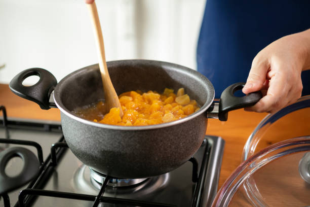 apricots boiling in pot stock photo
