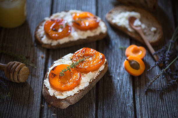 Apricots, goat cheese, honey and thyme Crostini stock photo