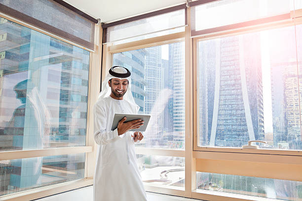 Arab businessman using digital tablet in Dubai office stock photo