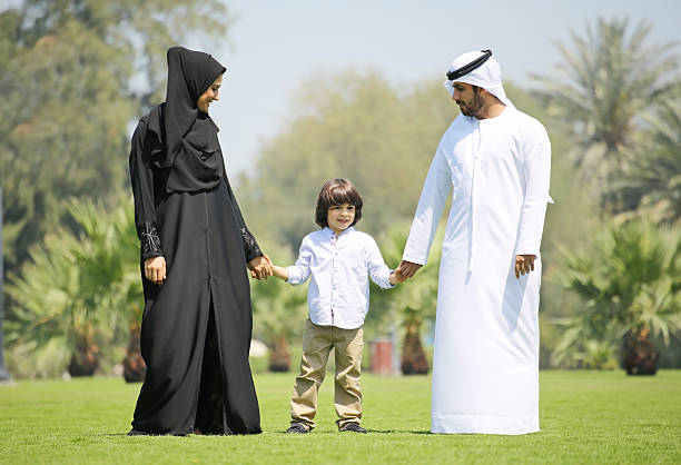 Arab family enjoying their leisure time in park stock photo