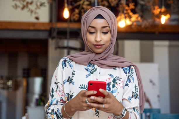 Arab italian texting on mobile and scrolling social media Arab italian texting on mobile and scrolling social media cute arab girls stock pictures, royalty-free photos & images