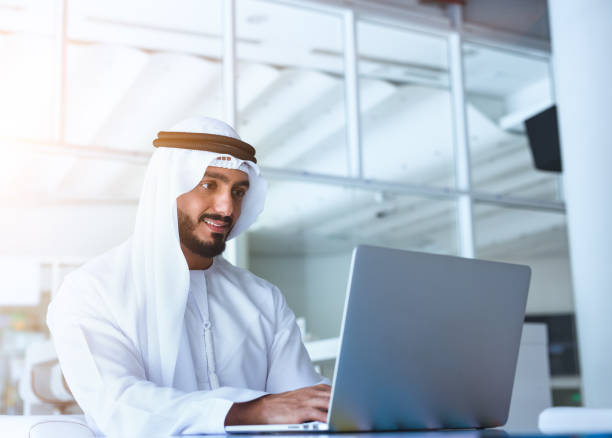 Arab Men Laptop Arab men working on laptop united arab emirates stock pictures, royalty-free photos & images