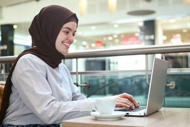 Arab woman working on laptop stock photo