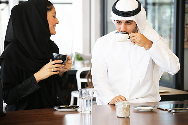Arabian couple enjoying leisure time in a cafe stock photo
