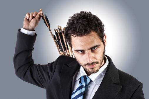 an elegant young businessman extracting an arrow from the quiver on his back