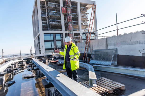 Architect inspects work at building site stock photo
