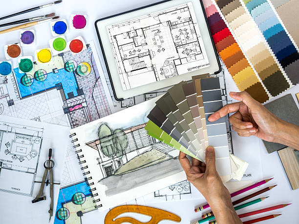 Architect, interior designer working at worktable with color swatch, sketch stock photo