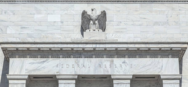 Architectural Detail on the U.S. Federal Reserve Building An eagle stands proudly above the door of the United States Federal Reserve which is located in the Eccles Building at 20th Street and Constitution Avenue NW in Washington, DC. The exterior of the building is comprised of Georgia marble. federal reserve stock pictures, royalty-free photos & images