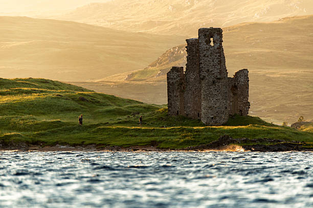 Ardvreck Castle,Scotland Sutherland, Scotland - August 24,2015: The tourist survey around Ardvreck Castle in the evening (golden hour) time. Ardvreck Castle is a ruined castle dating from the 16th century which stands on a rocky promontory jutting out into Loch Assynt in Sutherland, Scotland caithness stock pictures, royalty-free photos & images