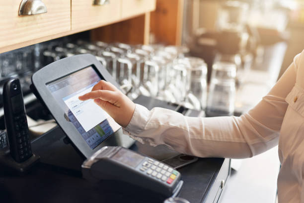 Shot of an unrecognizable woman punching in a order for a customer