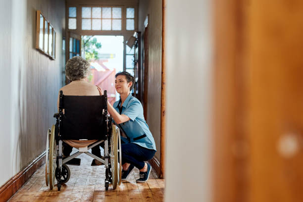 Are you ready for your walk/ Shot of a nurse caring for a senior patient in a retirement home home caregiver stock pictures, royalty-free photos & images