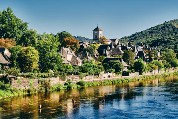 Argentat village south side of river, Dordogne, France South side of Argentat village in the Dordogne region of France. aquitaine photos stock pictures, royalty-free photos & images