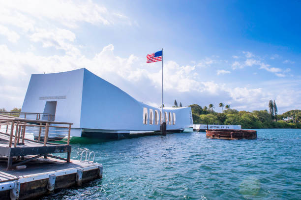 USS Arizona, Pearl Harbor Historic Sites in Honolulu, Hawaii, USA The USS Arizona Memorial in Pearl Harbor, Oahu, Hawaii view from a shuttle boat arriving at the pier at Honolulu, Hawaii, USA. pearl harbor stock pictures, royalty-free photos & images