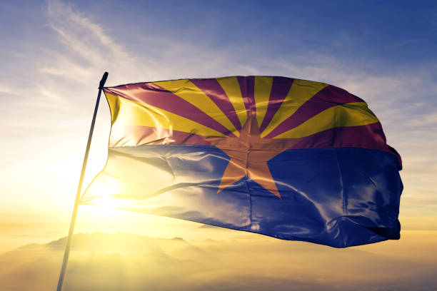 Arizona state of United States  flag textile cloth fabric waving on the top sunrise mist fog stock photo