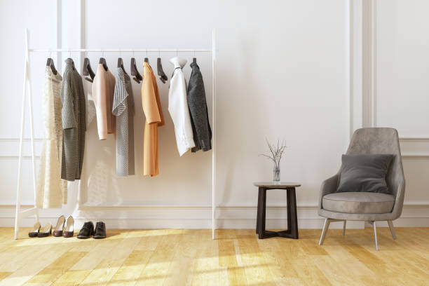 Armchair And Hanging Clothes In The Dressing Room Armchair And Hanging Clothes In The Dressing Room womenswear stock pictures, royalty-free photos & images