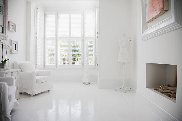 armchairs and fireplace in elegant, white living room - white room bildbanksfoton och bilder