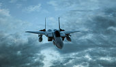 Armed military fighter jet in flight on the cloudly sky background - 3d render.